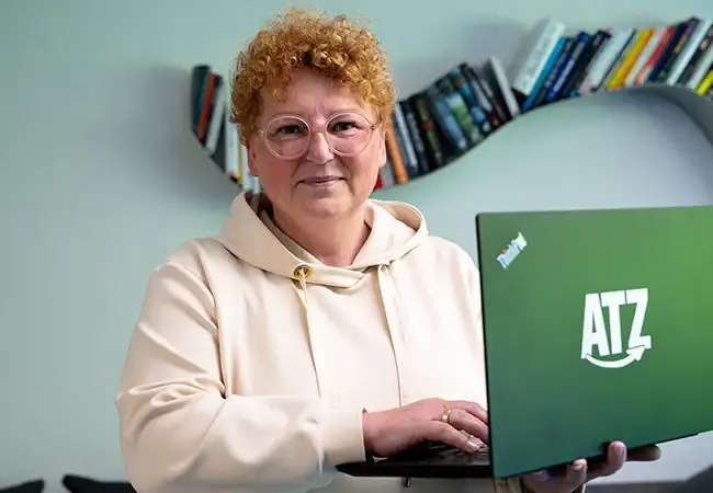 ATZ Group Head of IT holding a laptop
