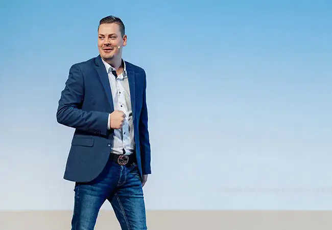 ATZ Group sales employee wearing a lavalier microphone delivering a speech